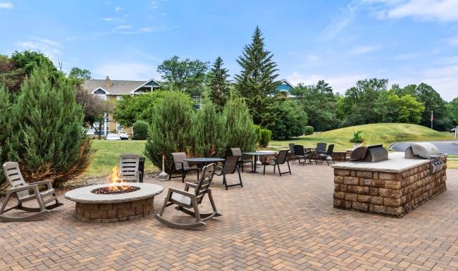 Access to resident-only features a patio with tables and chairs