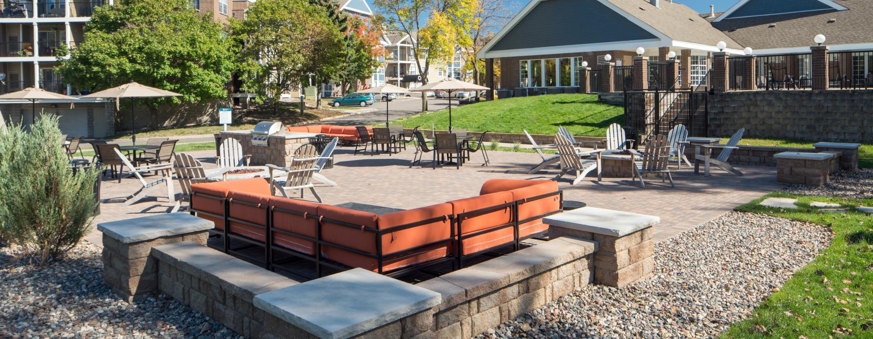 a backyard with a pool and a large brick patio
